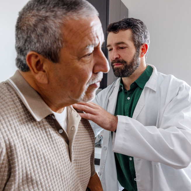 Doctor examining an older male patient during a clinical checkup