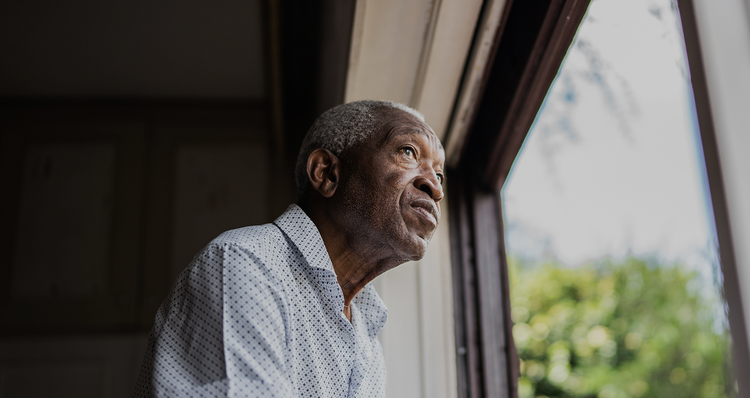 An older man looking out of a window