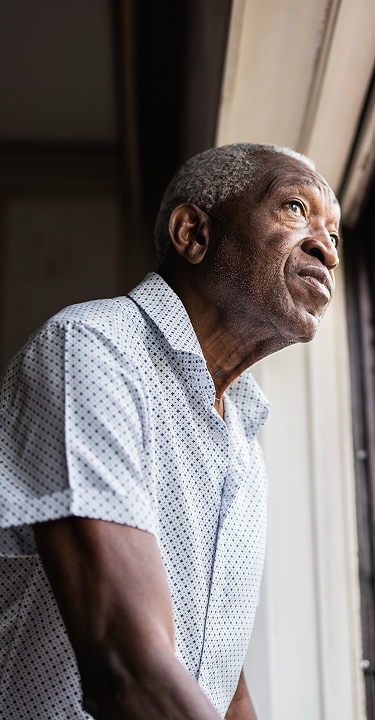 An older man looking out of a window