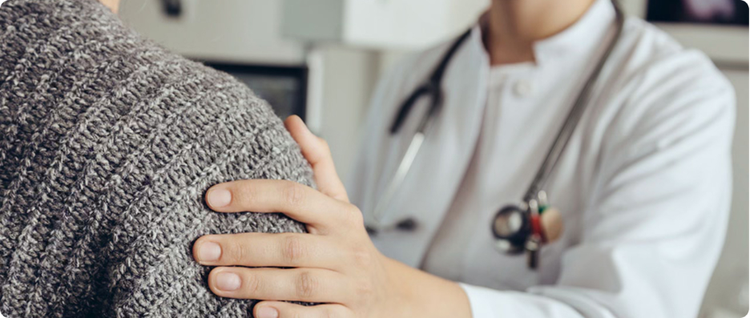 doctor offering support to patient while discussing migraine symptoms