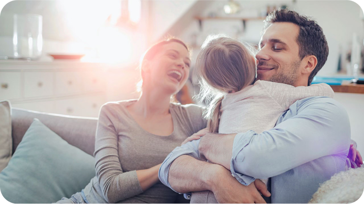 smiling parents holding their daughter demonstrating their relief