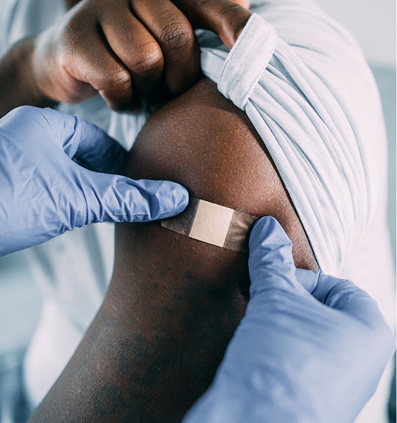 A healthcare professional applying a bandage to an arm
